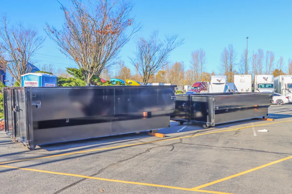 Professional dumpster rental service with roll-off container on residential driveway in Poquoson